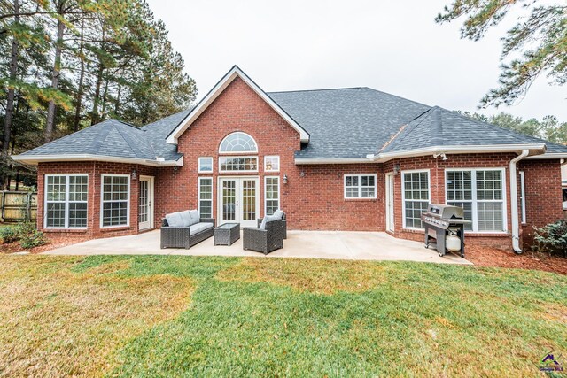 rear view of house featuring a patio area, outdoor lounge area, a yard, and french doors