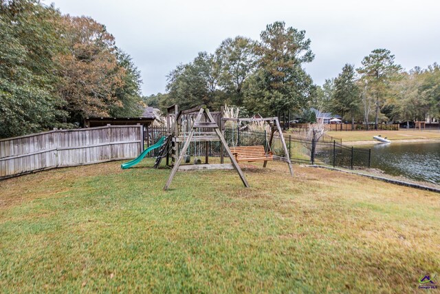 view of yard featuring a playground and a water view