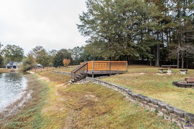 view of yard with a deck with water view