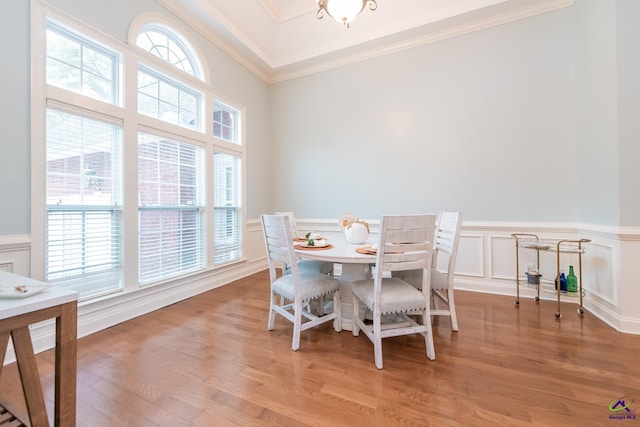 dining space with light hardwood / wood-style flooring and crown molding