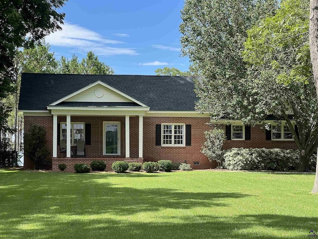 view of front of property with crawl space, roof with shingles, a front lawn, and brick siding