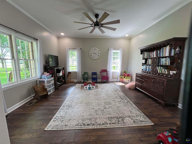 living area with dark hardwood / wood-style flooring, ornamental molding, and ceiling fan