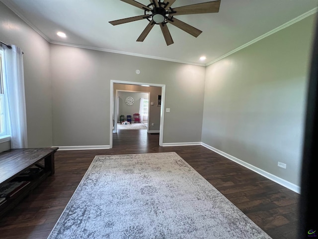 interior space with dark hardwood / wood-style floors, ornamental molding, and ceiling fan