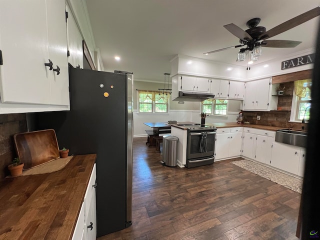 kitchen featuring butcher block counters, sink, stainless steel range with electric stovetop, and ceiling fan