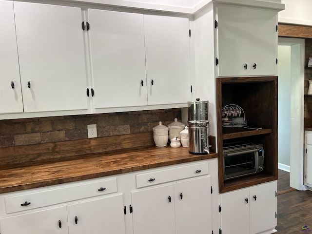 kitchen featuring wooden counters, dark wood-type flooring, backsplash, and white cabinets