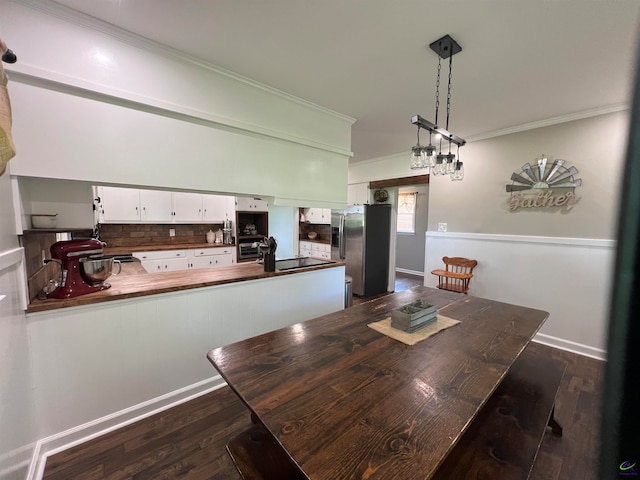 dining area with dark hardwood / wood-style flooring and ornamental molding