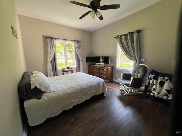 bedroom with multiple windows, hardwood / wood-style flooring, and ceiling fan