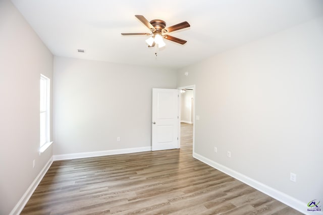 spare room featuring ceiling fan and hardwood / wood-style flooring