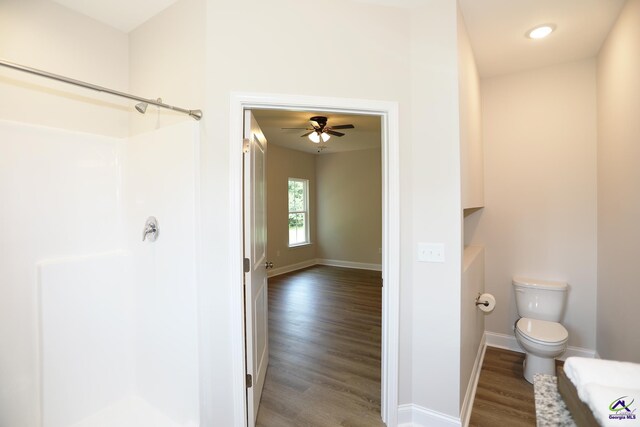 bathroom with toilet, hardwood / wood-style floors, and ceiling fan