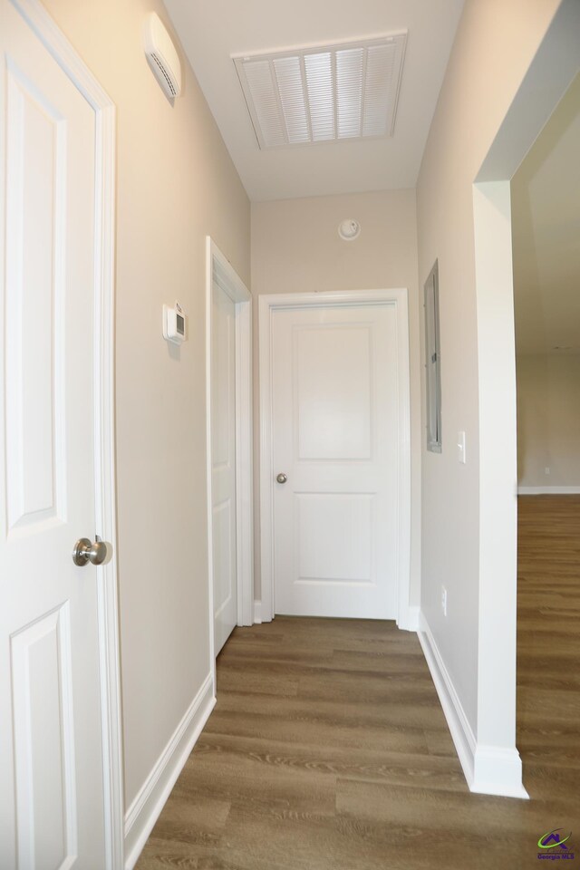 hall with electric panel and hardwood / wood-style flooring