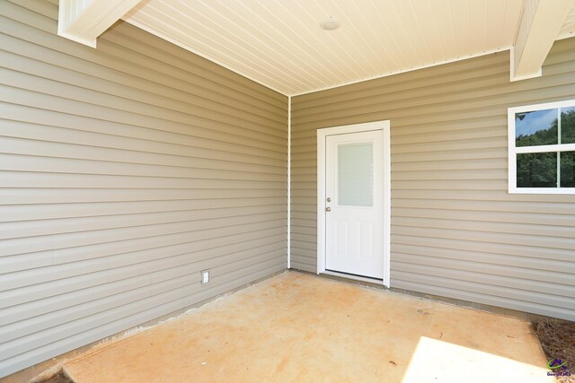 property entrance featuring a patio