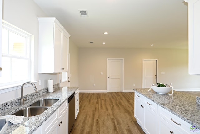 kitchen featuring white cabinets, sink, light wood-type flooring, light stone countertops, and dishwasher