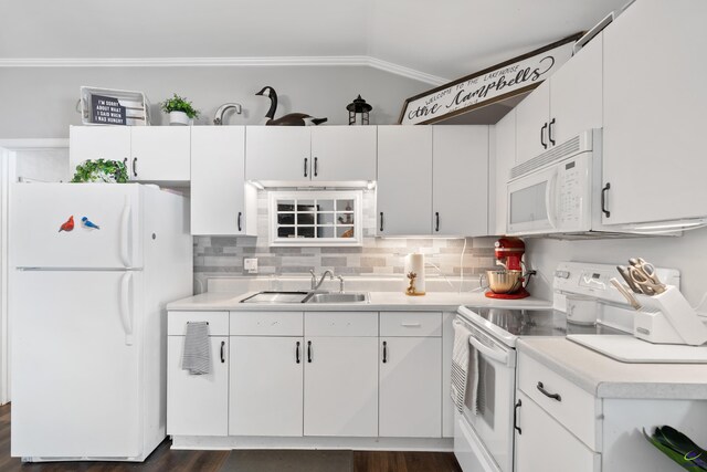 kitchen featuring dark hardwood / wood-style flooring, white cabinets, white appliances, sink, and vaulted ceiling