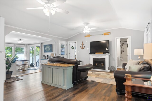 living room featuring ornamental molding, lofted ceiling, ceiling fan, and hardwood / wood-style floors