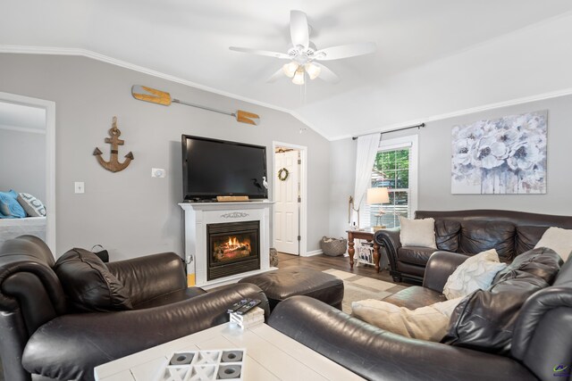 living room featuring ceiling fan, wood-type flooring, vaulted ceiling, and ornamental molding