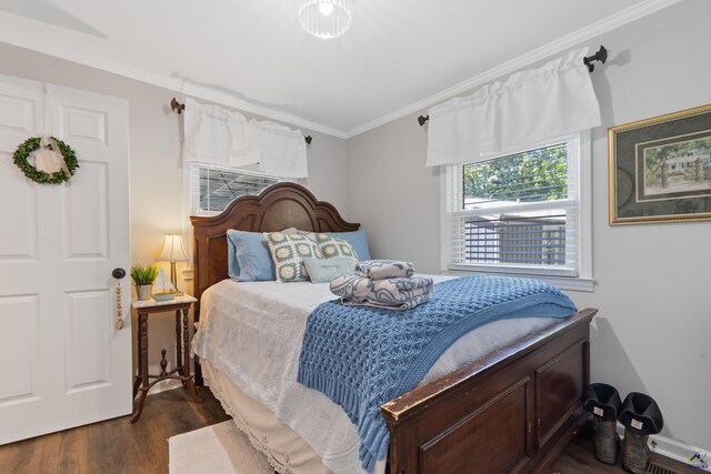 bedroom featuring dark hardwood / wood-style floors and ornamental molding