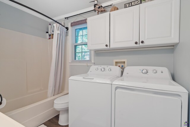 laundry area featuring ornamental molding, separate washer and dryer, and hardwood / wood-style floors