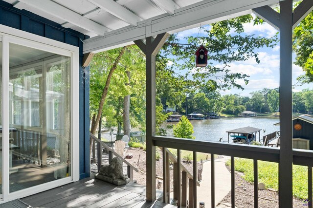 wooden terrace with a dock and a water view