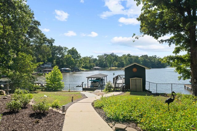 view of front of property with a water view and a boat dock