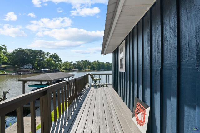 balcony featuring a boat dock and a water view