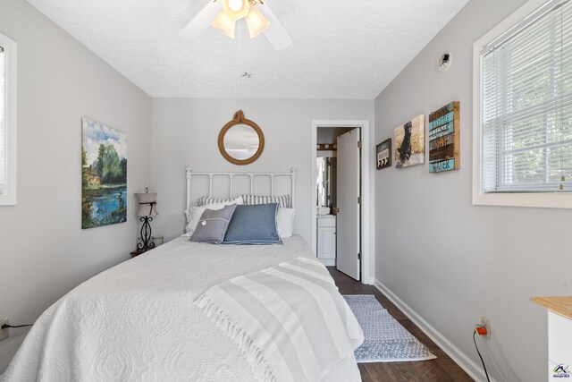 bedroom with a textured ceiling, ceiling fan, and dark hardwood / wood-style floors