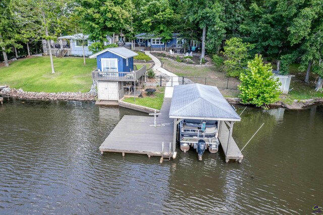 dock area with a water view and a lawn