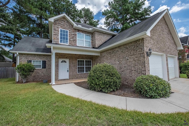 view of front of home with a front yard and a garage