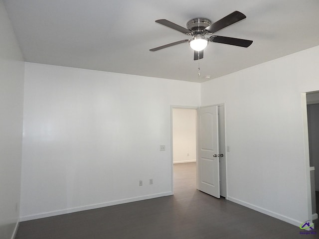 unfurnished room featuring ceiling fan, dark wood-type flooring, and baseboards