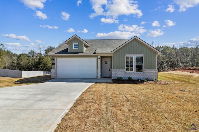 view of front of property with concrete driveway, brick siding, a front lawn, and an attached garage