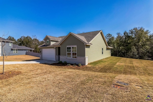 view of front of home featuring an attached garage, a front lawn, concrete driveway, and brick siding