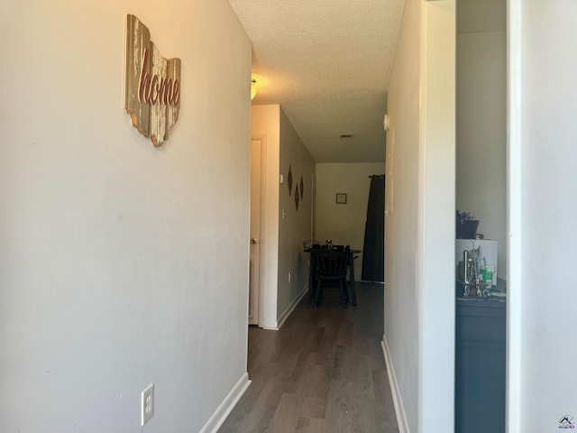 hall featuring hardwood / wood-style floors and a textured ceiling