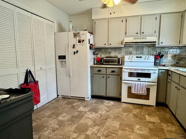 kitchen featuring cream cabinetry, white appliances, tasteful backsplash, light tile patterned floors, and ceiling fan