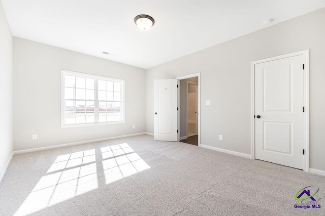 unfurnished bedroom with light colored carpet