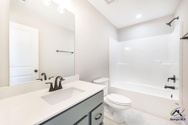 full bathroom featuring visible vents, toilet, marble finish floor, washtub / shower combination, and vanity