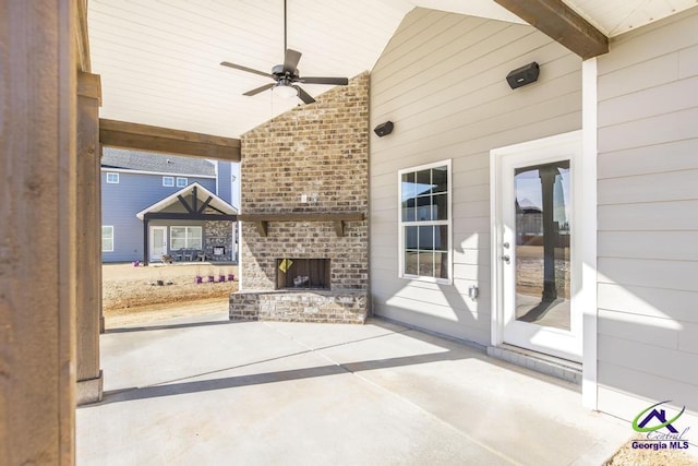 view of patio with ceiling fan and an outdoor brick fireplace