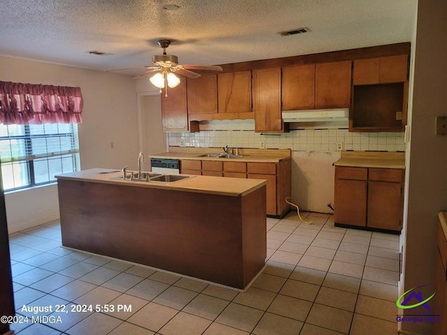 kitchen featuring ceiling fan, backsplash, light tile patterned flooring, and sink