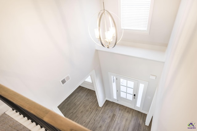 foyer with an inviting chandelier, hardwood / wood-style floors, and plenty of natural light