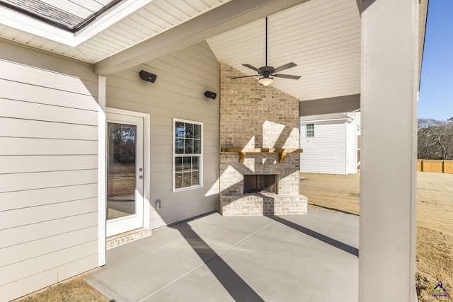 view of patio / terrace featuring ceiling fan and an outdoor brick fireplace