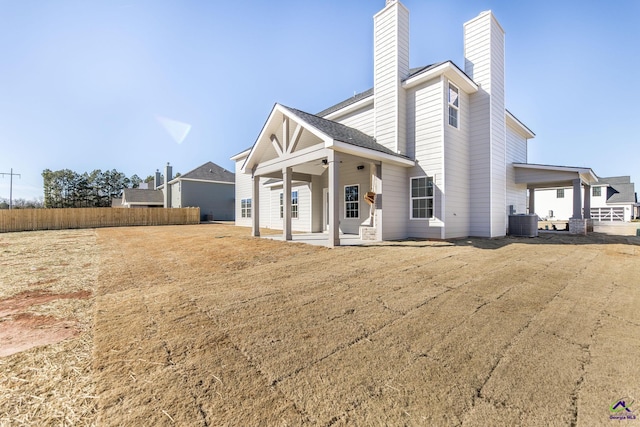 back of house with central AC unit, ceiling fan, and a patio