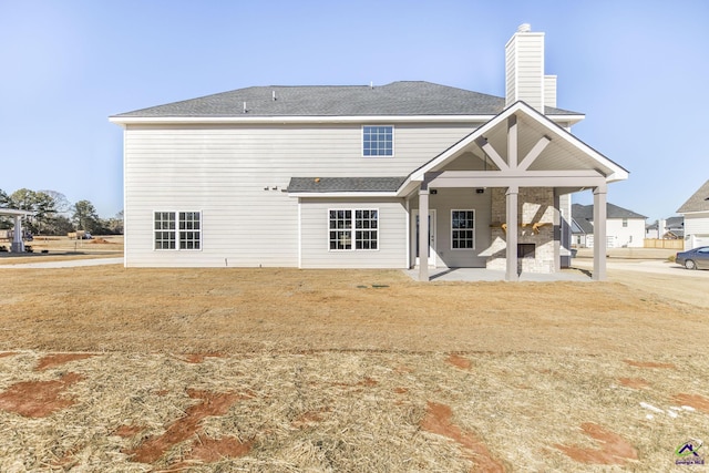 rear view of property with a patio area and a yard