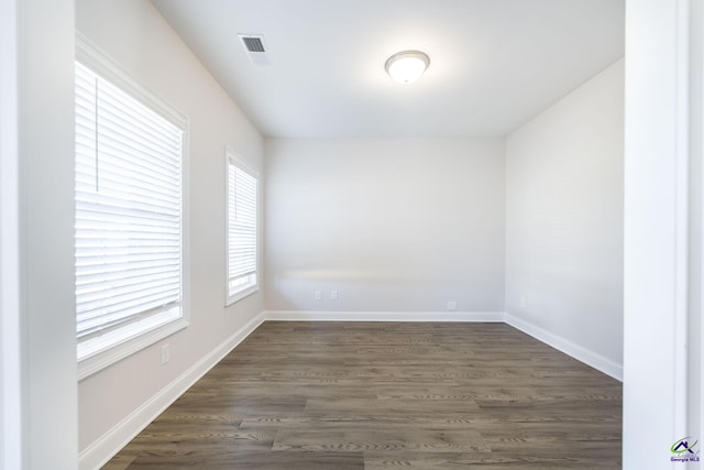 spare room with dark hardwood / wood-style floors