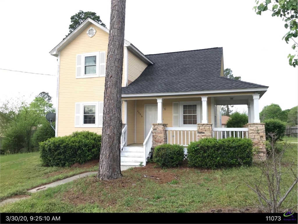 view of front of house featuring a front yard and a porch