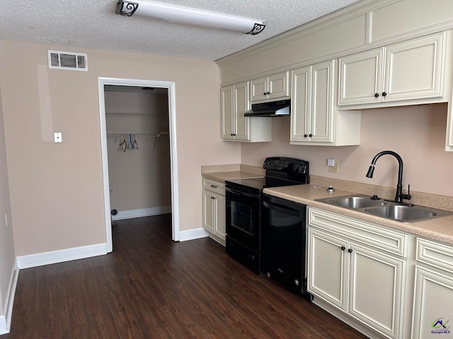 kitchen featuring a textured ceiling, dark hardwood / wood-style floors, black appliances, sink, and white cabinets