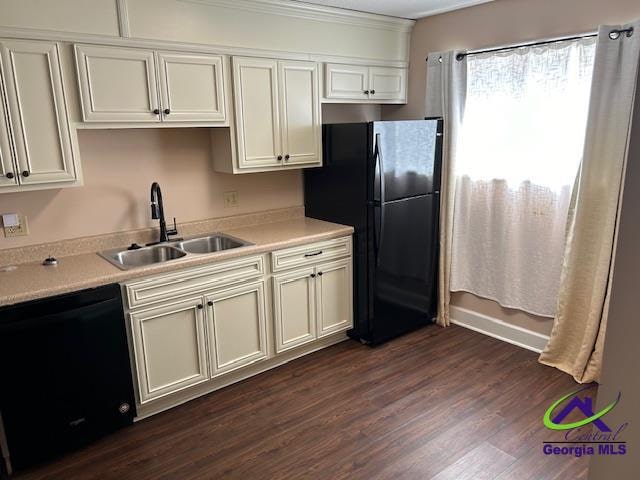 kitchen featuring black appliances, sink, and dark hardwood / wood-style floors