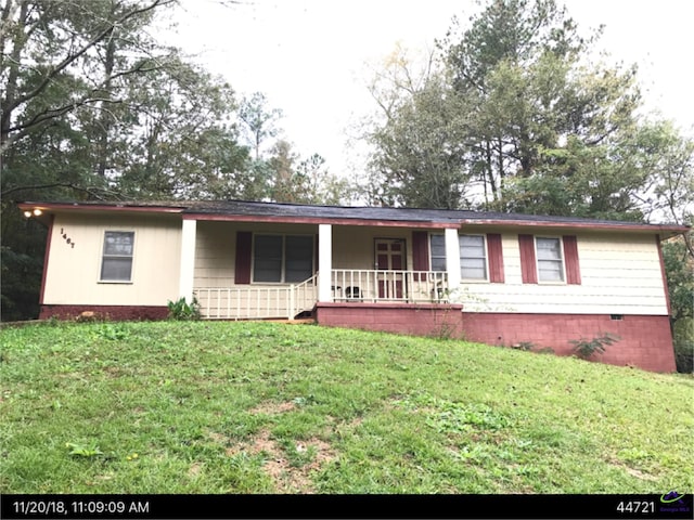 ranch-style home with a porch and a front lawn