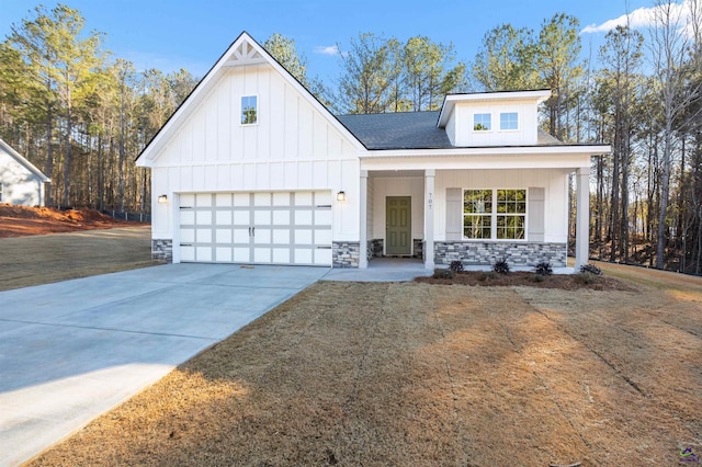 707 Jasmine Dr, Macon, GA 31211 - modern inspired farmhouse featuring board and batten siding, driveway, stone siding, and covered porch