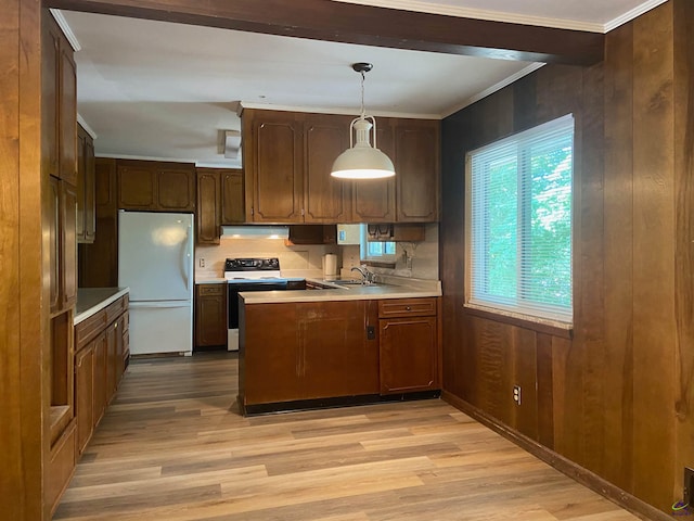 kitchen featuring decorative light fixtures, kitchen peninsula, light hardwood / wood-style floors, and white appliances