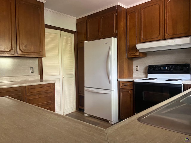 kitchen featuring crown molding, dark wood-type flooring, and white appliances