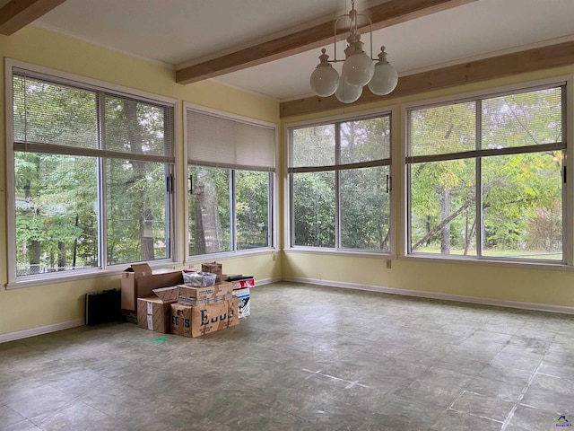 unfurnished sunroom with an inviting chandelier, beamed ceiling, and plenty of natural light