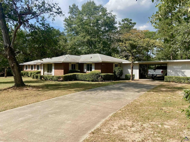 ranch-style house with a front yard and a carport